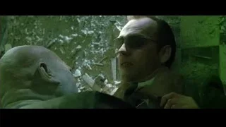 two bald men conversing in dimly lit room — The Matrix