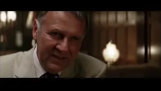 man in beige suit in dimly lit room — Batman
