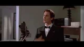 Man in tuxedo with camera on tripod — American Psycho