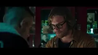 Two men in dimly lit bar with red door — Deadpool