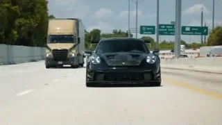 black sports car driving on highway — Sports Cars