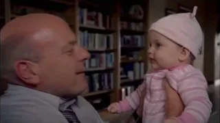 bald man holding baby in living room — Breaking Bad