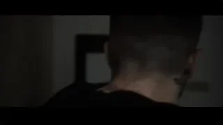 Two men in suits walking dark hallway — Southpaw