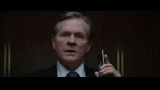 man in suit holding phone — Iron Man 3