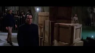 man in black coat by wooden crates — Bruce Lee: Enter The Dragon