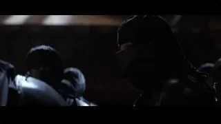 Person in hooded cloak crouching in dark room — Batman