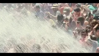 crowd at music festival with hands in air — Jurassic World