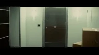 closed metal door in room with white walls — Limitless