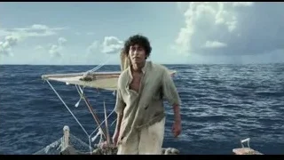 young man standing on boat in ocean — Life of Pi