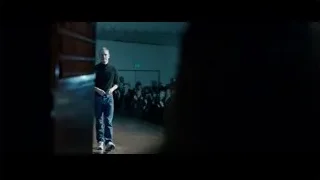 Man walking runway in dim room — Steve Jobs