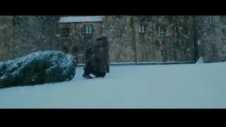 person with sword walking to snowy castle — Harry Potter and the Philosophers Stone