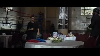 Two men conversing in room with boxing ring — Southpaw