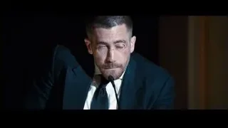 man in suit sitting with microphone — Southpaw
