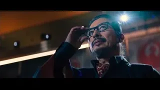 person reading on brick wall in garden at night — John Wick: Chapter 4