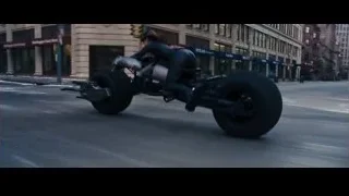 Man riding motorcycle on city street — Batman: The Dark Knight Rises