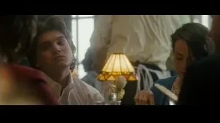 young man and women around table in dim room — Into the Wild