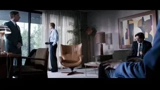 three men in living room with large windows — Jobs