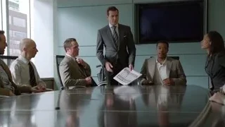 Man speaking at conference table — Suits