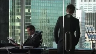 man in suit reading newspaper at desk — Suits