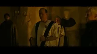 men in robes in dimly lit stone room — Gladiator 2