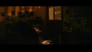 person's face in dark with red light — Whiplash