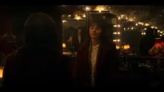 Young woman in red coat looking in mirror — Peaky Blinders