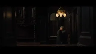 man walking through grand hall with chandelier — Creed 2