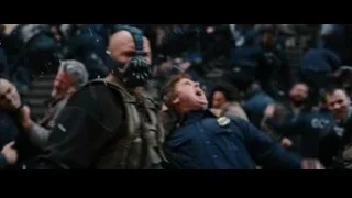 man in gas mask confronting people — Batman: The Dark Knight Rises