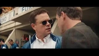 man in blue jacket walking on race track — Ford v Ferrari
