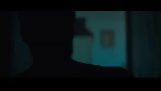 silhouette in dimly lit room with blue light — Creed 2