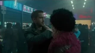 man and woman in crowded street at night — Blade Runner 2049