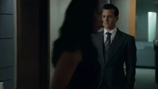 man in suit standing in office hallway — Suits