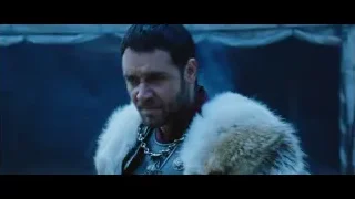 Man in fur coat by stone wall in dark setting — Gladiator