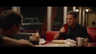 two men eating at restaurant table — Ford v Ferrari