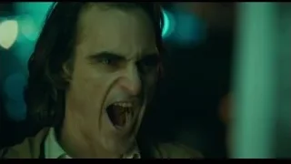 Man's face with serious expression in dimly lit room — Joker