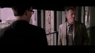 Two men in suits by large window — Spider Man 2