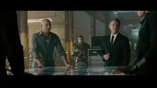 Three men conversing around glass table — Furious Seven