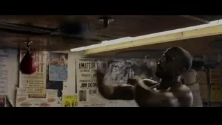man punching bag in boxing ring — Creed