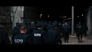 Police officers walking through city alleyway — Batman: The Dark Knight Rises