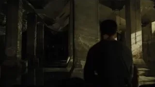 Person in dark abandoned building hallway — Blade Runner 2049