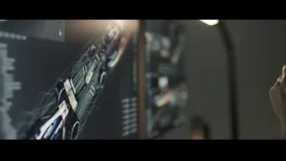 Woman working on multiple computer monitors — F1