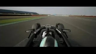 Black race car speeding on track — F1