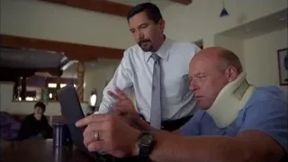 Man with neck brace looking at tablet — Breaking Bad