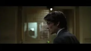Young man in suit by window blinds — Batman