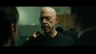 bald man looking intently at another man — Whiplash