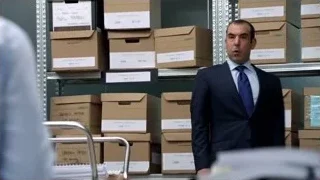 man in suit by shelf of boxes — Suits