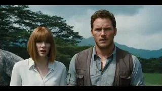 man and woman standing in mountain field — Jurassic World