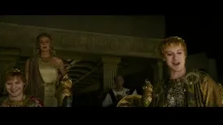 Woman speaking to men in armor in ornate room — Gladiator 2