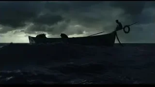 Two people fishing in boat at night — Life of Pi