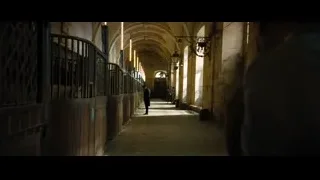 two men in stone corridor with arches — John Wick: Chapter 4